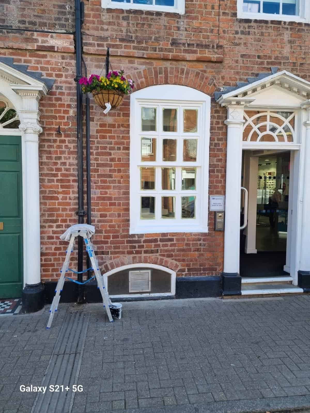 Brick townhouse frontage with repainted sash windows
