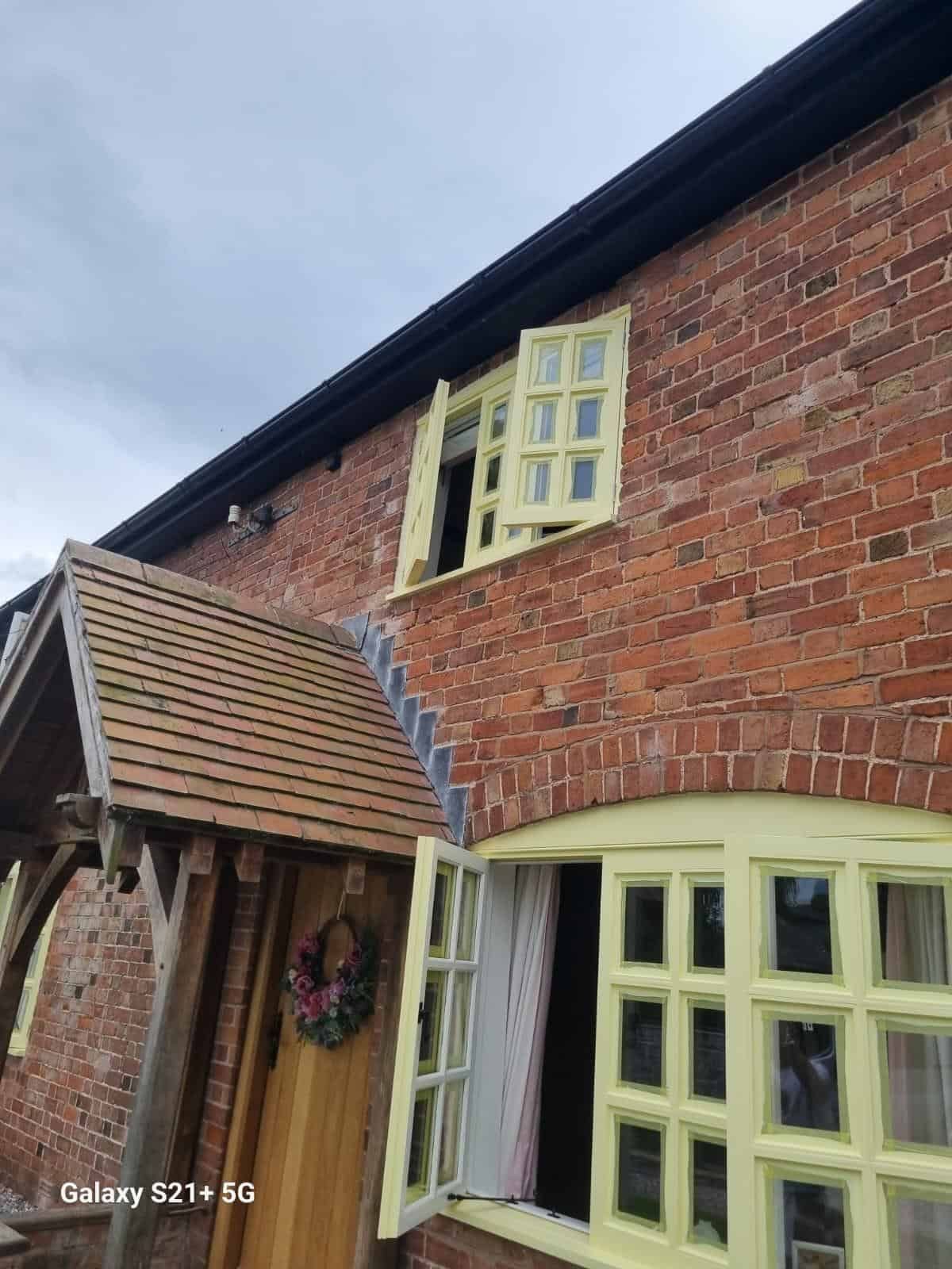 Farmhouse porch and casement windows after painting