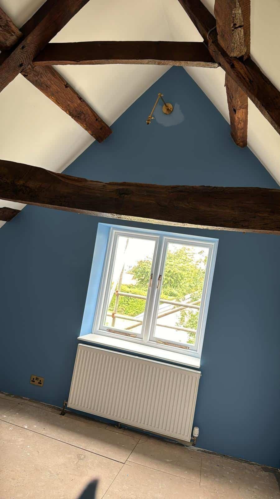 Bedroom window beneath painted gable
