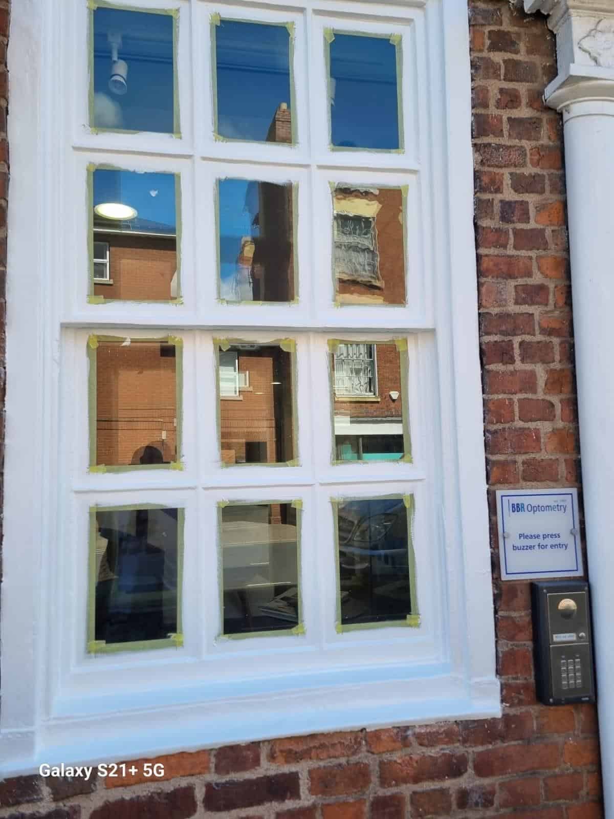 Close-up of white painted sash window