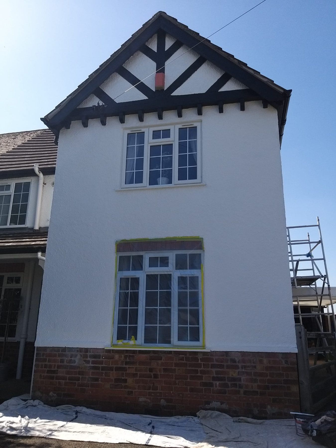 Rendered gable wall repainted white