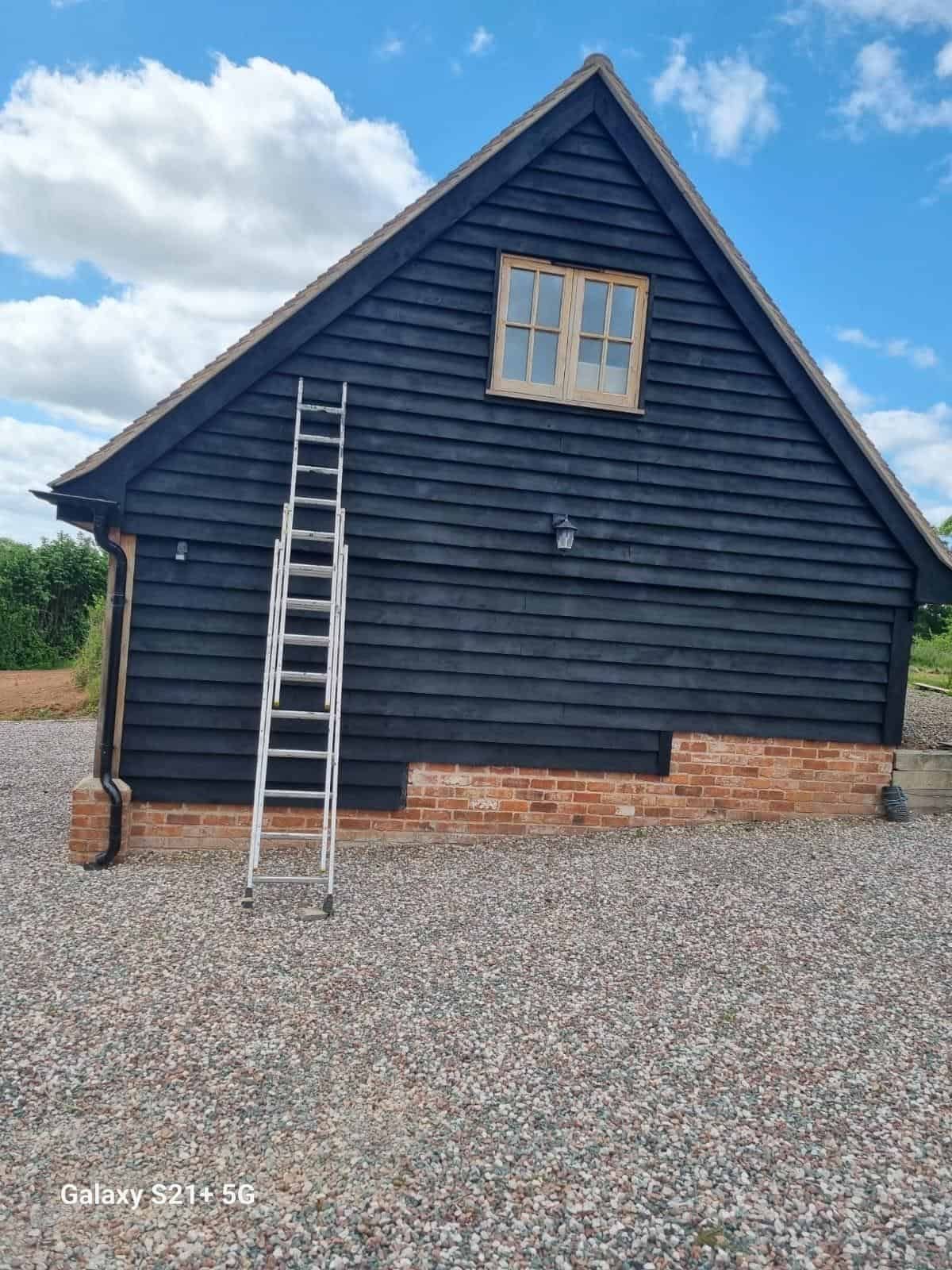 Black painted gable with small window