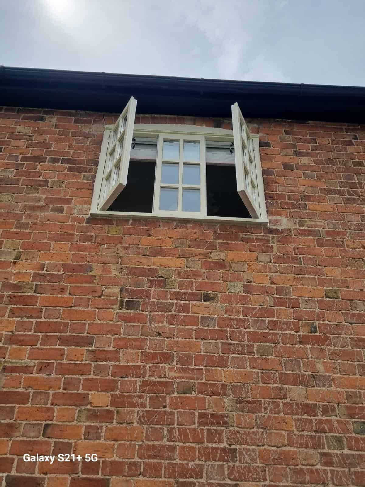 Upper floor casement window open for painting