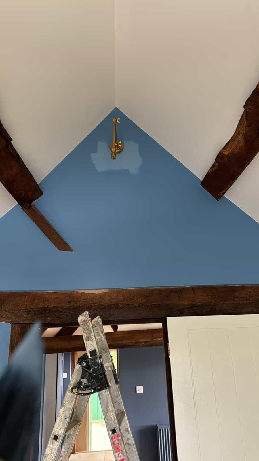Blue painted wall below oak beam