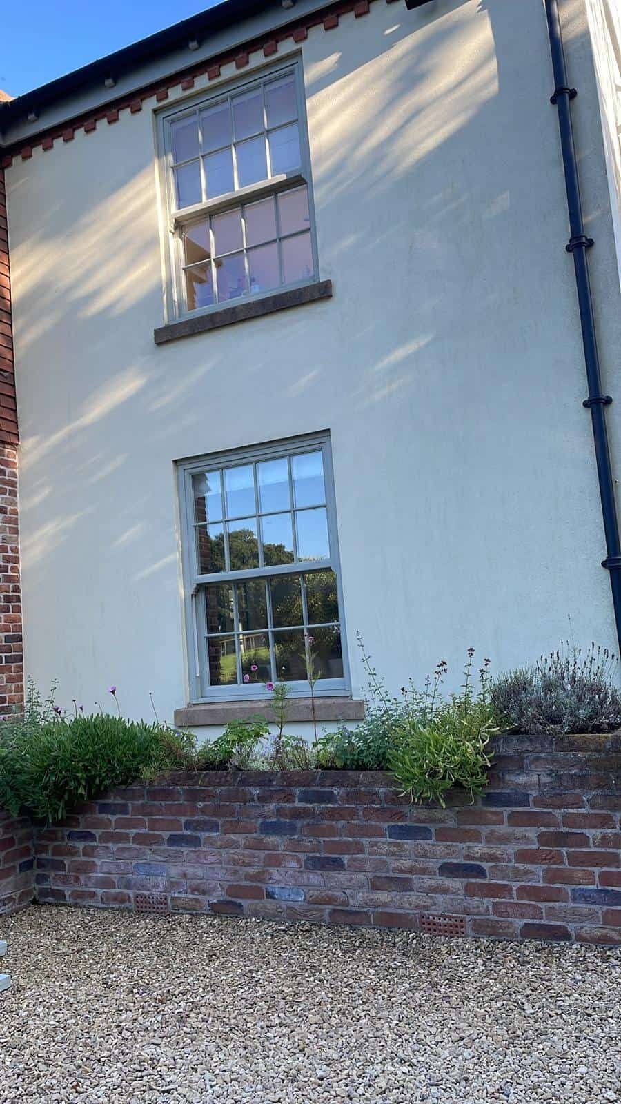Rendered wall with sash windows after painting