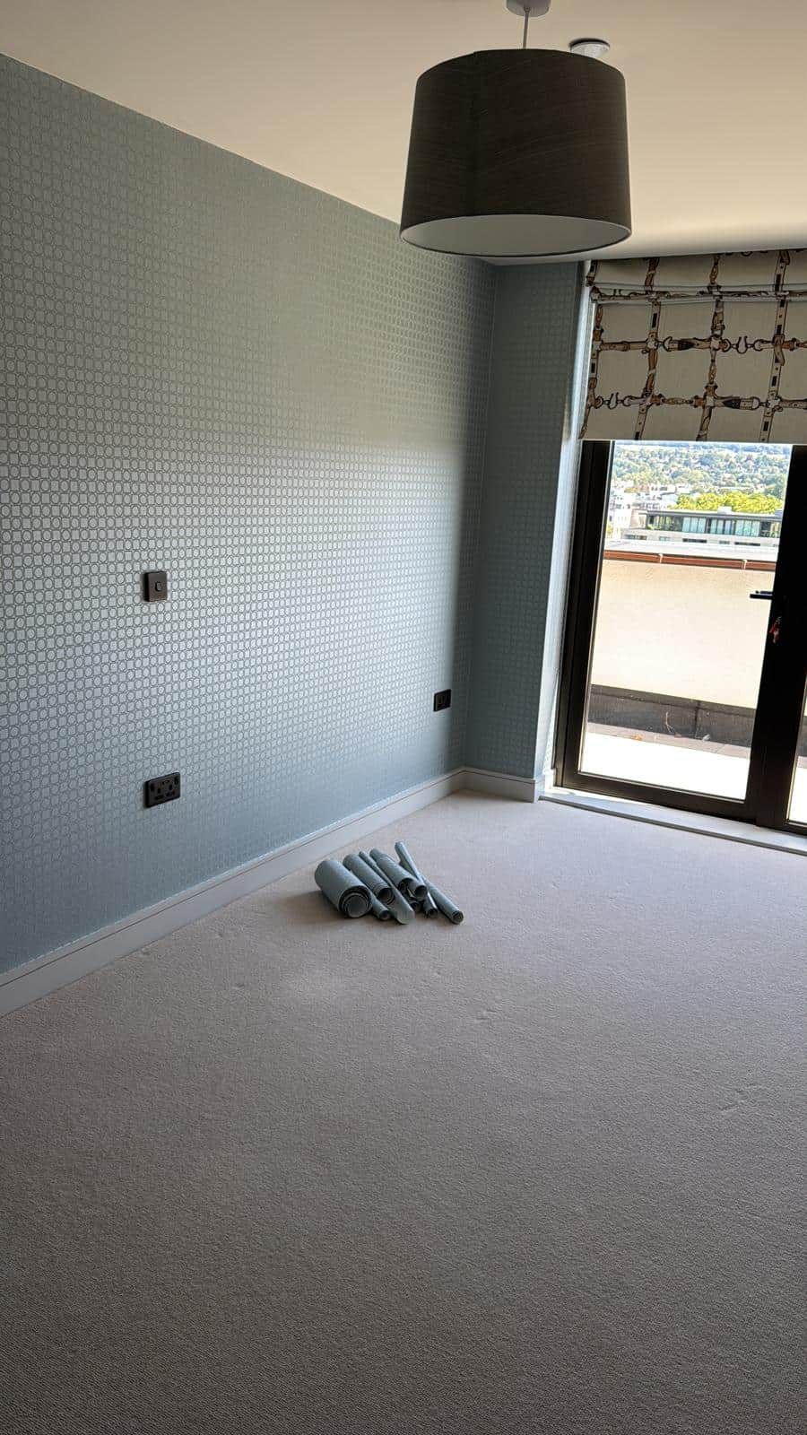 Grey patterned wallpaper in finished bedroom