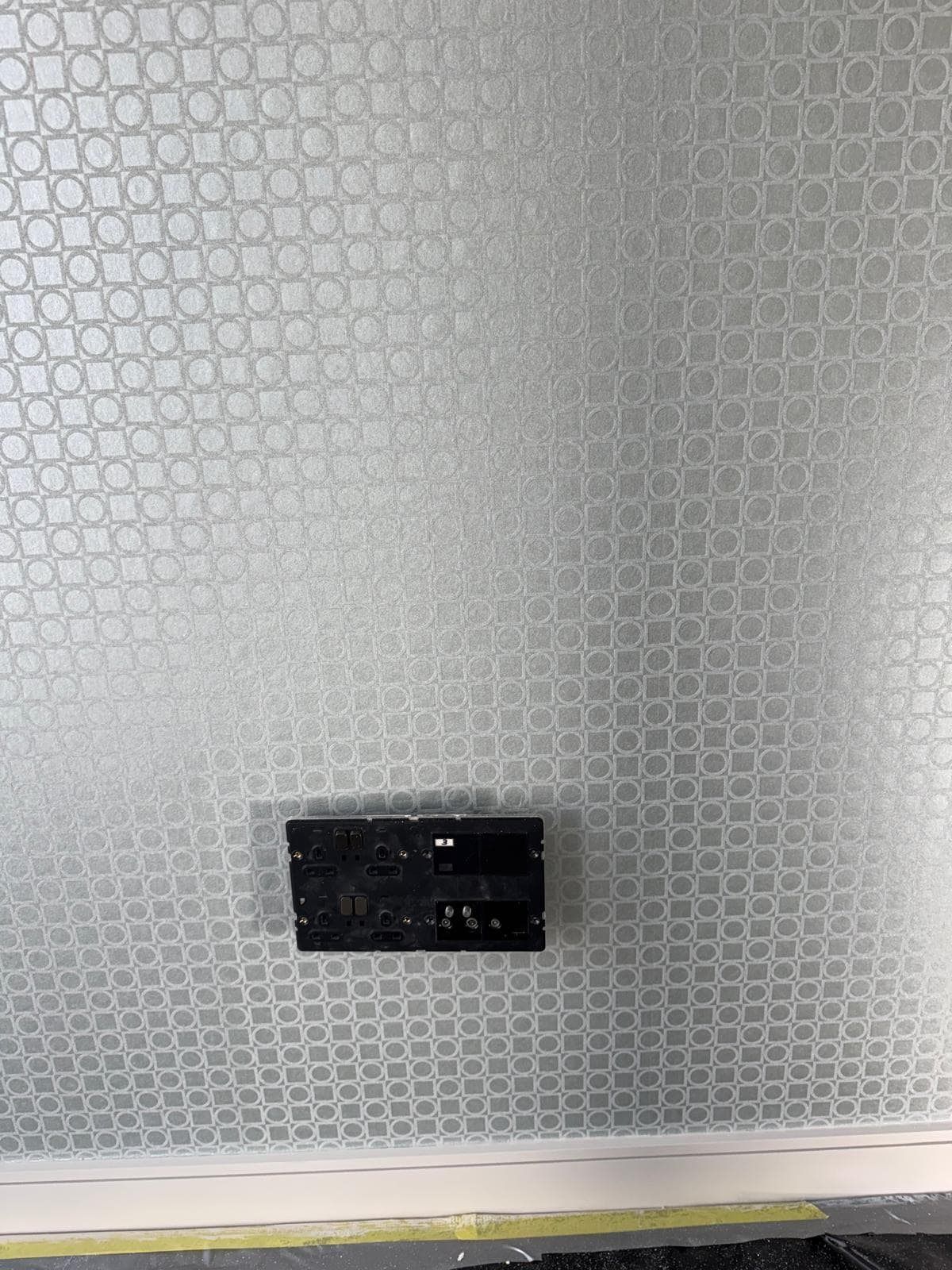 Close-up of wallpaper pattern around a socket