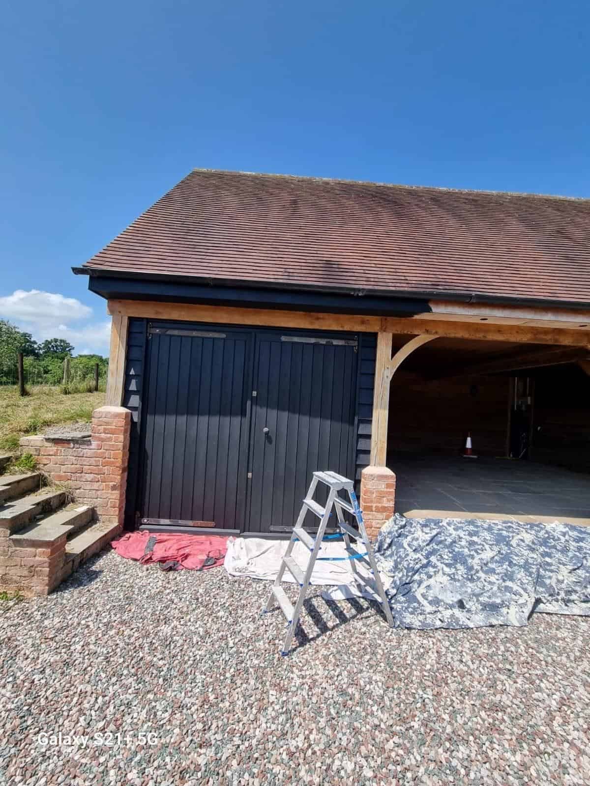 Timber garage building with open car port