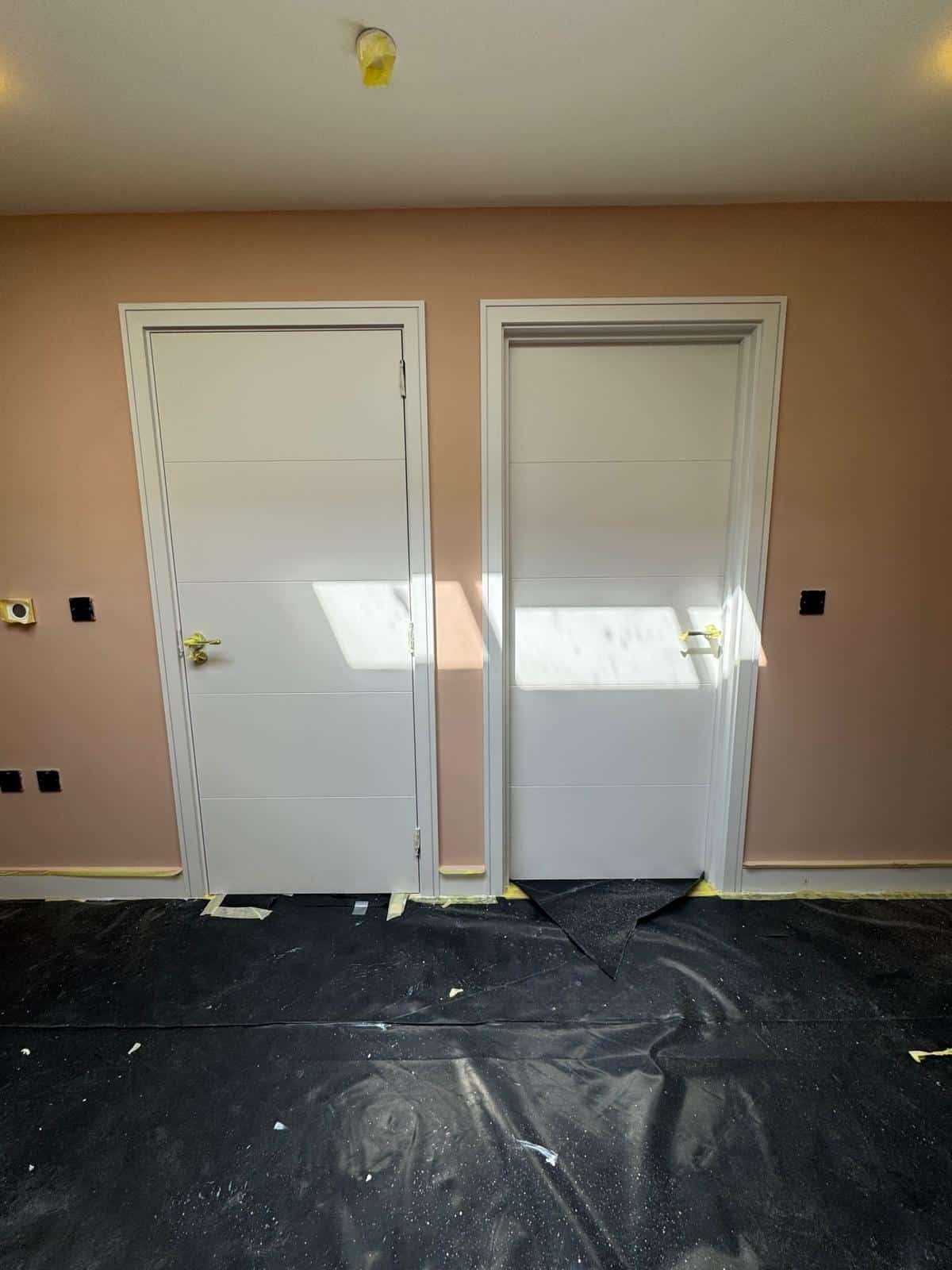 Doors in a pink painted hallway