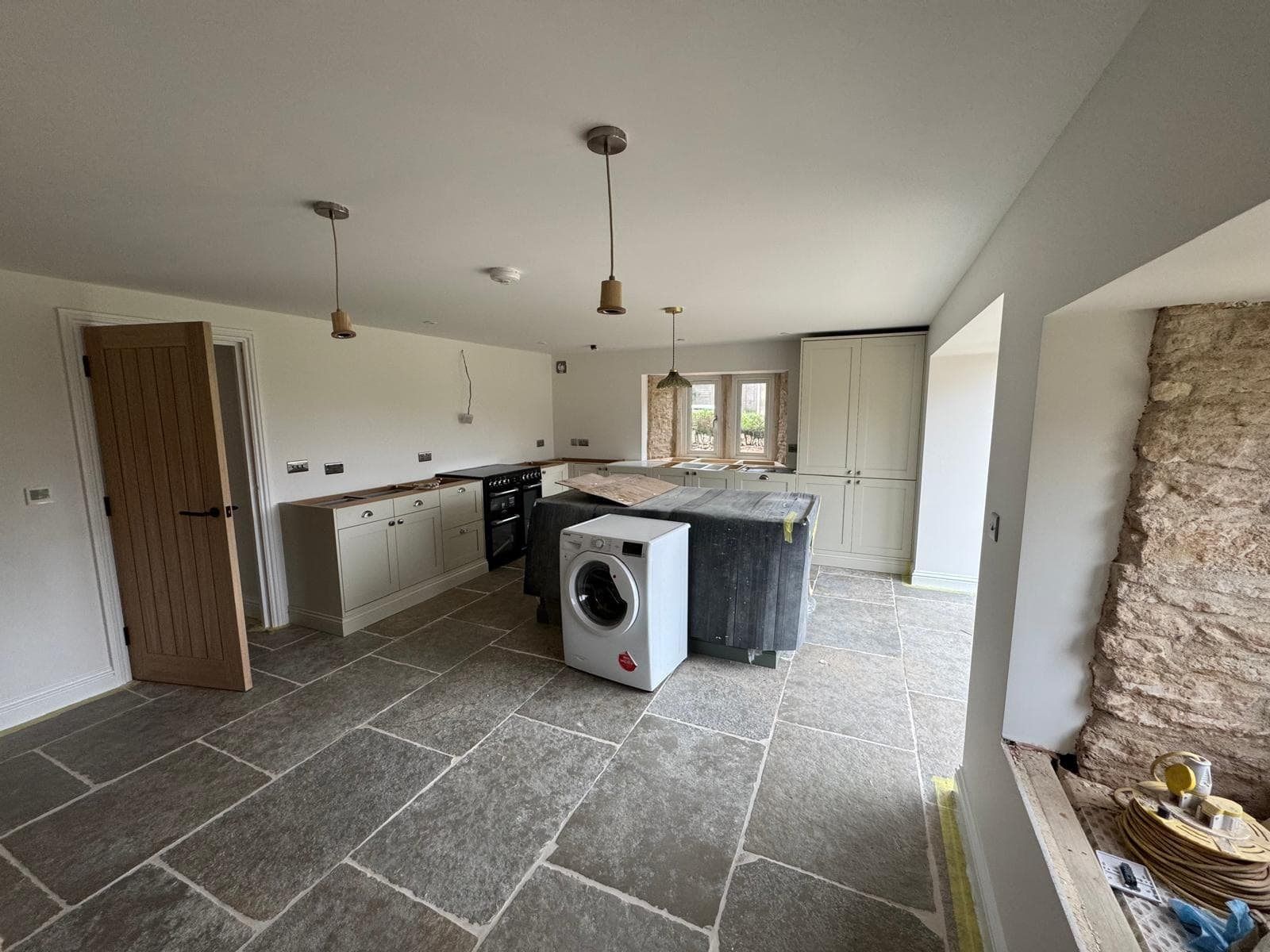 Kitchen with exposed stone chimney breast